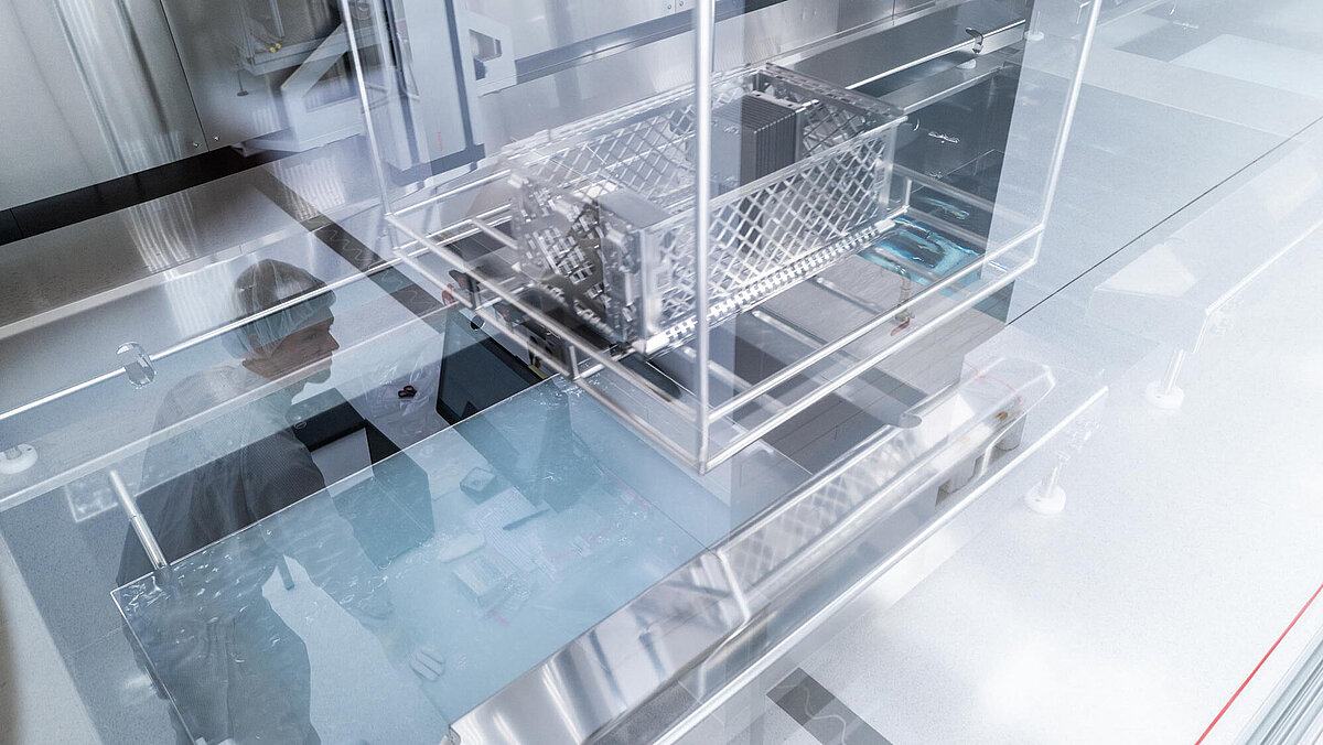 Ultrasonic Cleaning; Baskets filled with components which travel into an ultrasonic cleaning bath